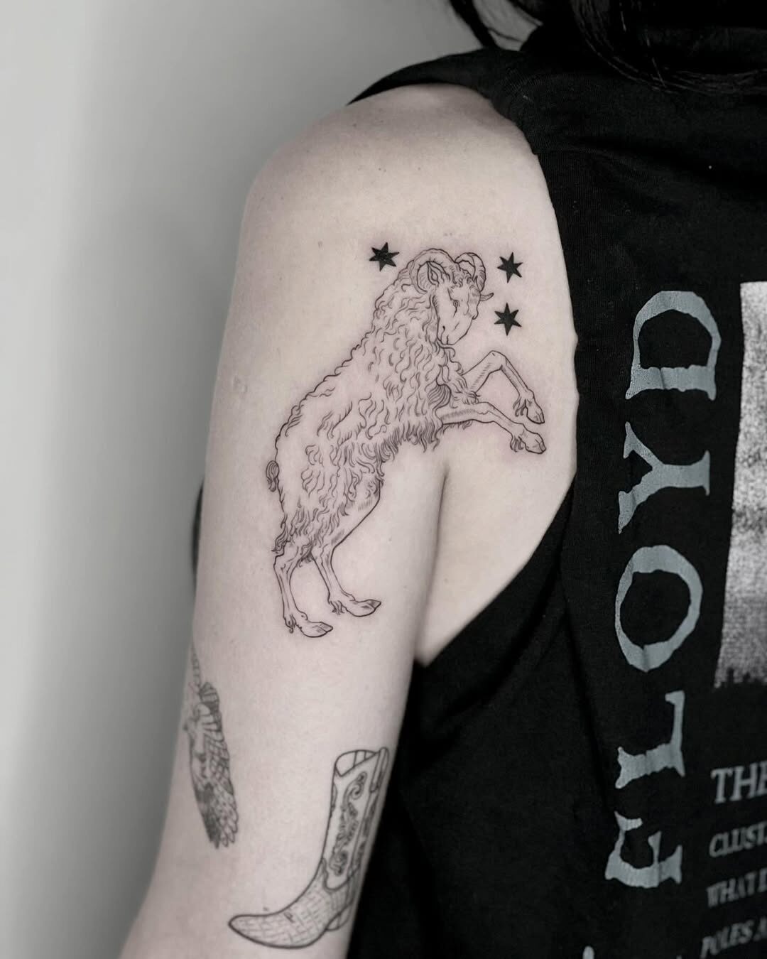 Charming goat tattoo with celestial accents