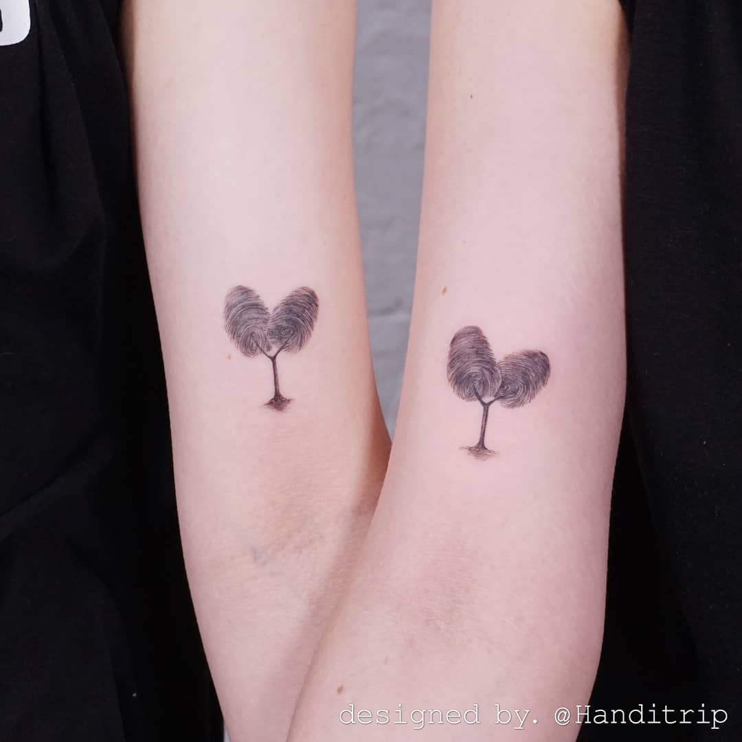 Symbolic heart-shaped tree twin tattoos