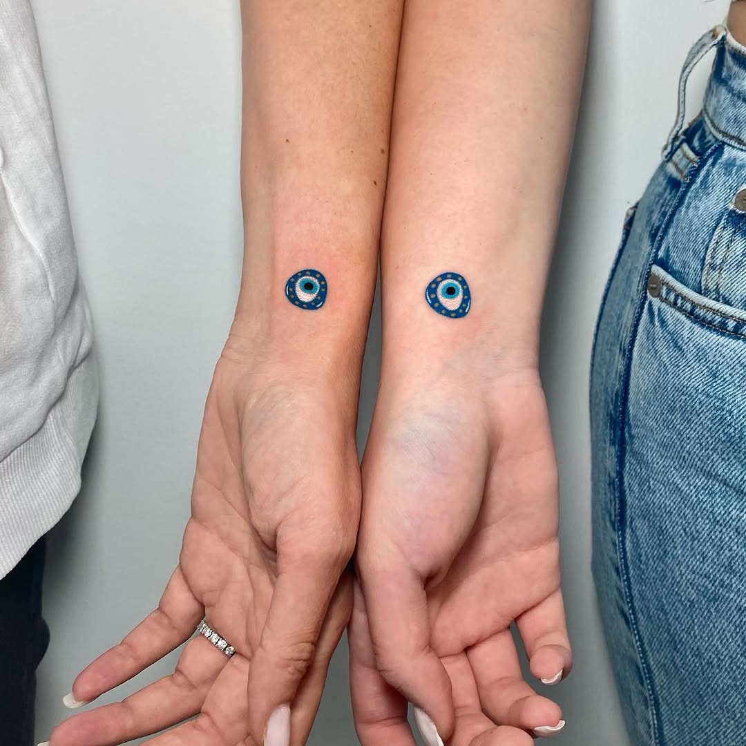 Stylish twin tattoos with blue circle design