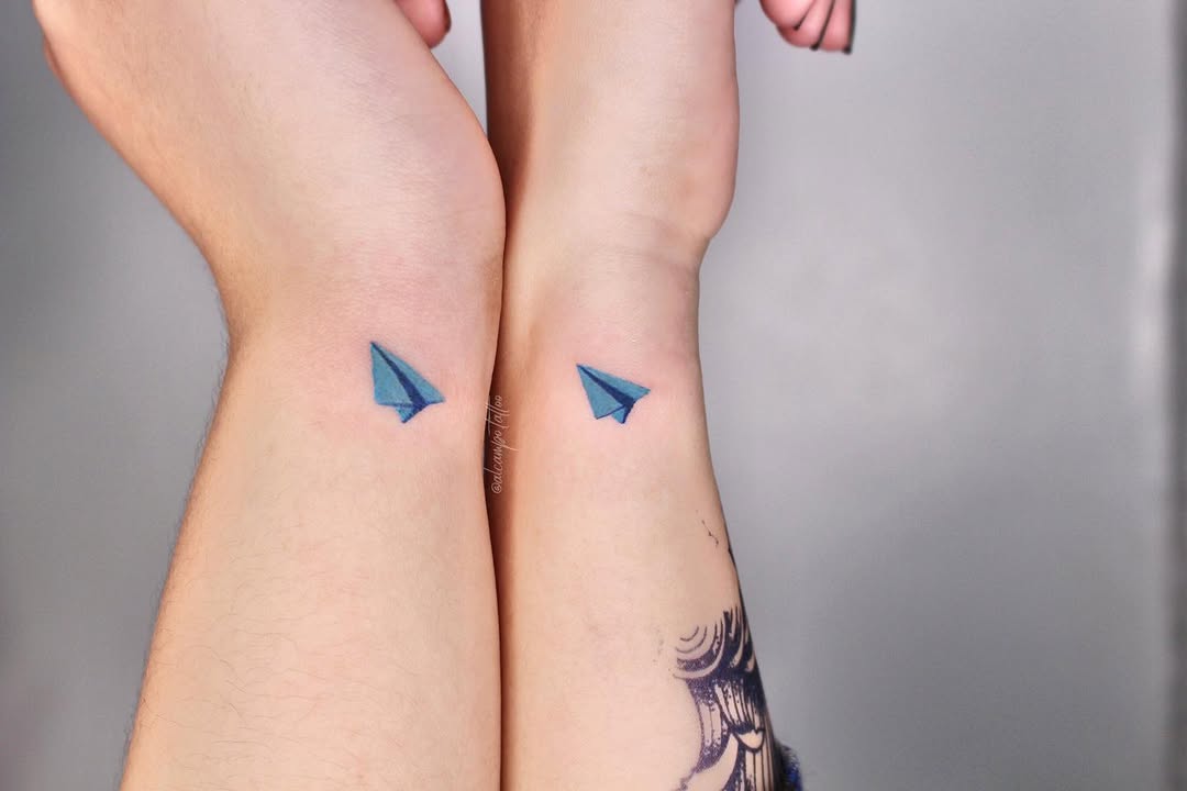 Minimalistic Twin Paper Airplane Tattoos in Blue