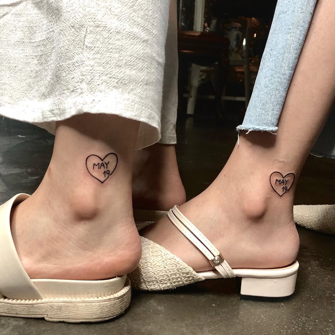 Delicate twin ankle heart tattoos