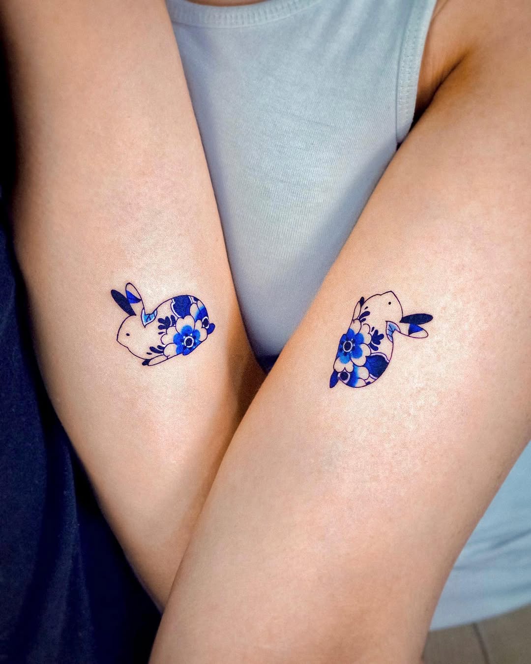 Charming floral bunny twin tattoos