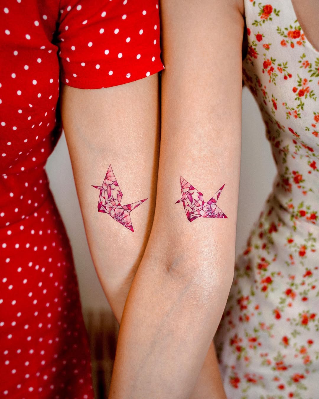 Artistic twin crane tattoos with floral patterns