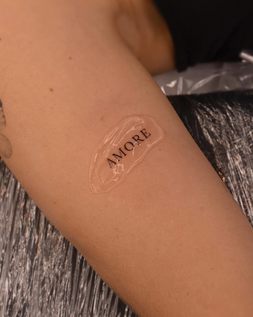 Elegant 'Amore' Tattoo Design on Skin