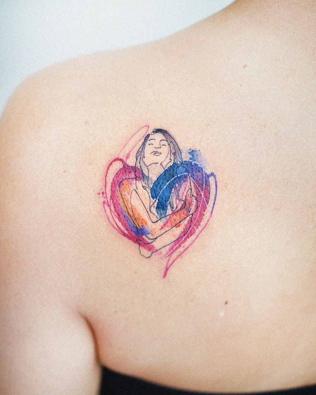 Vibrant watercolor woman tattoo on back