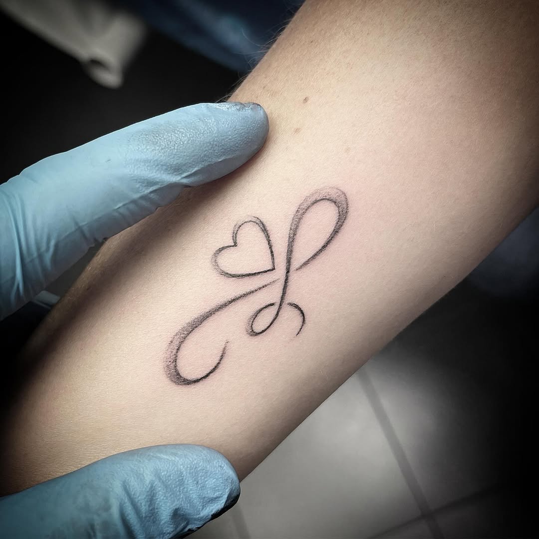 Minimalist infinity heart tattoo design