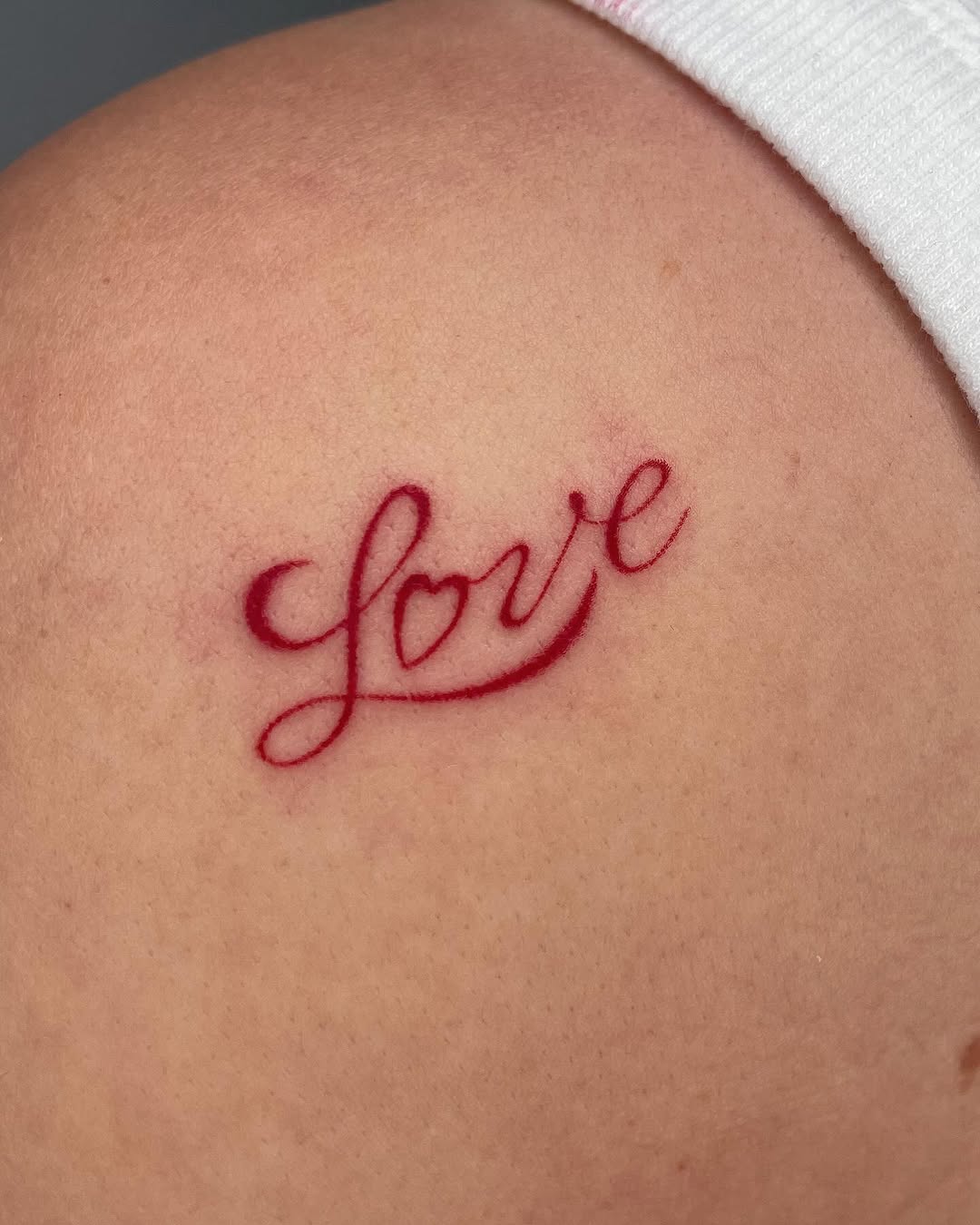 Elegant red cursive love tattoo design