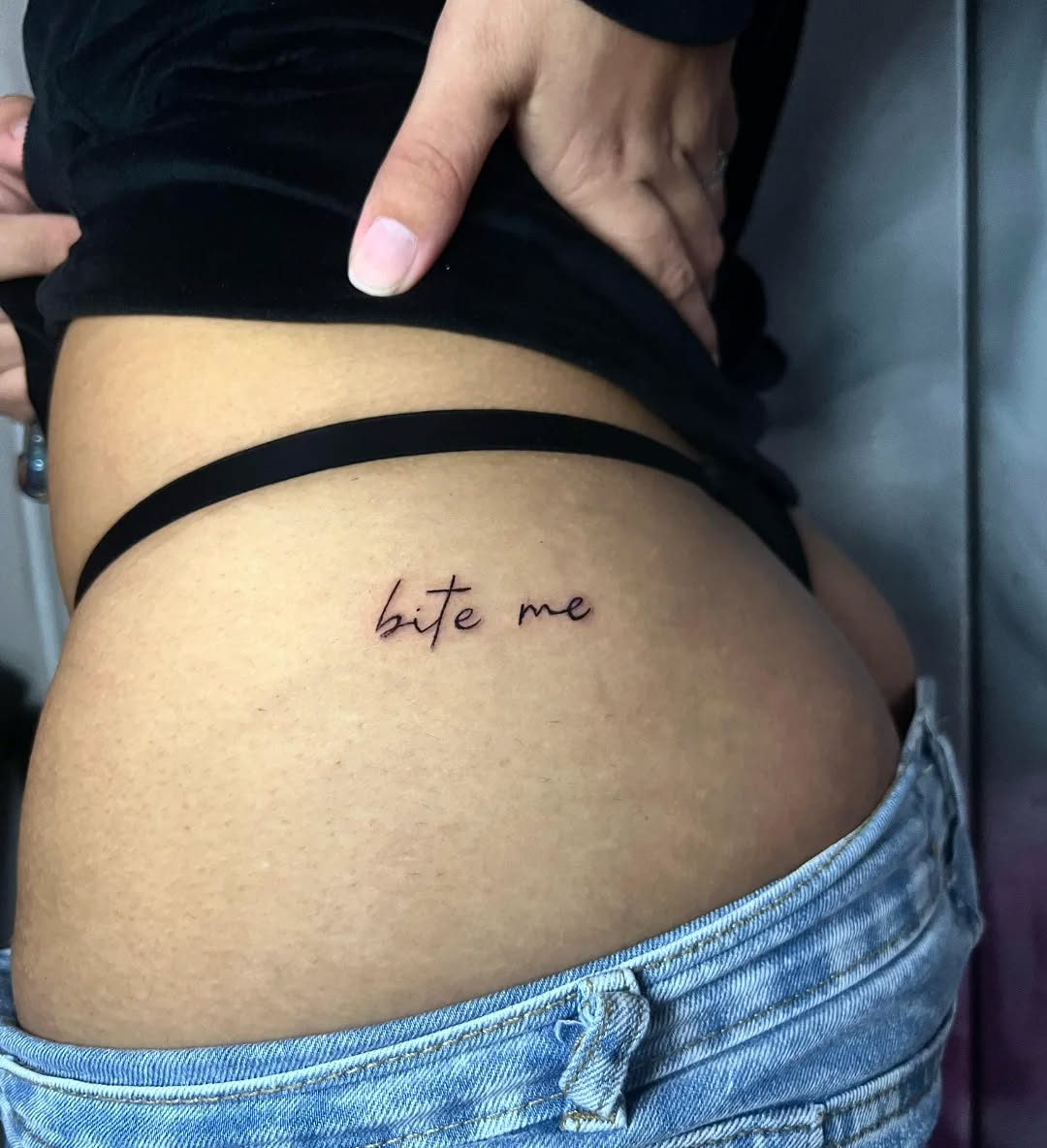 Playful lower back tattoo with attitude