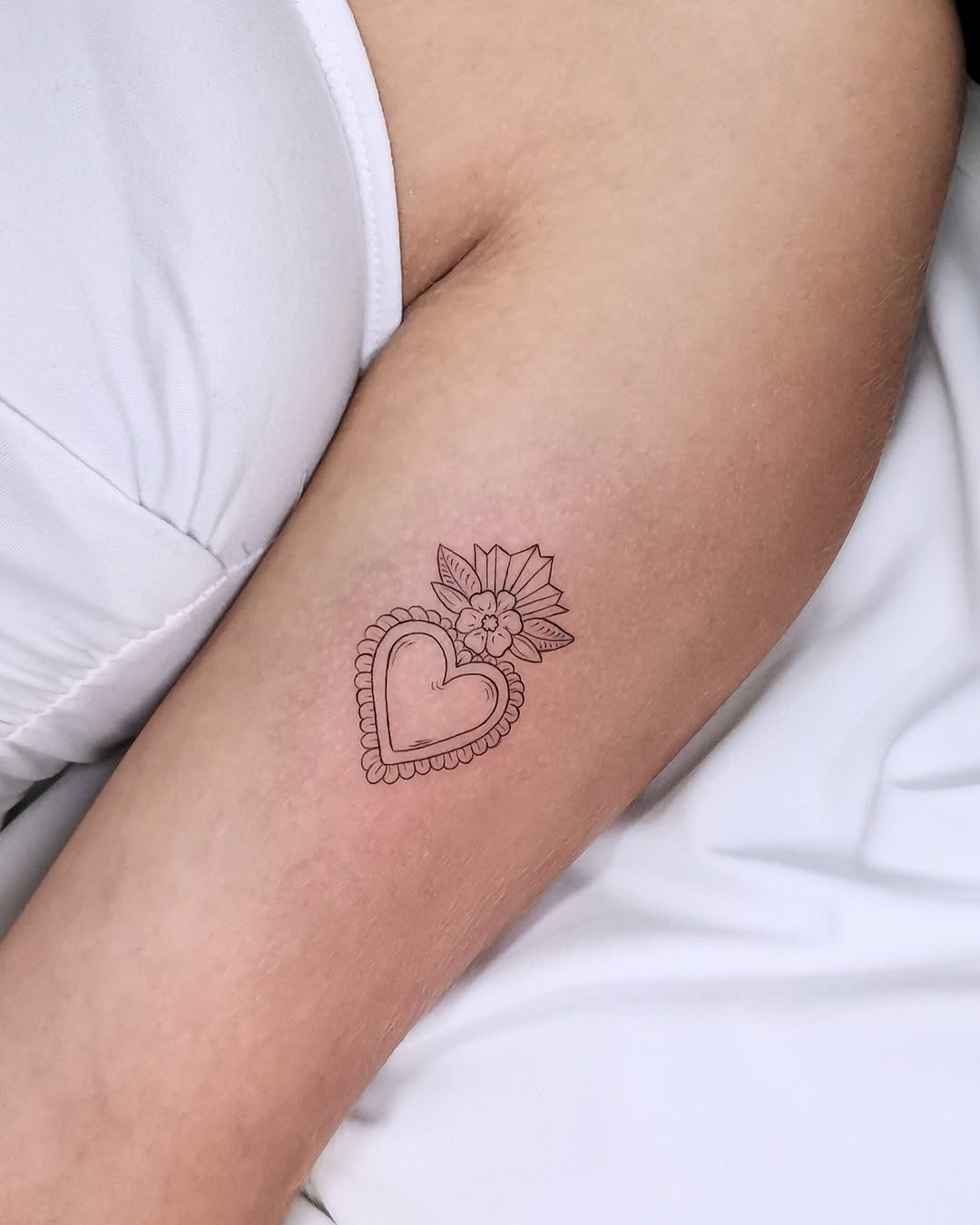 Beautiful heart tattoo with floral elements