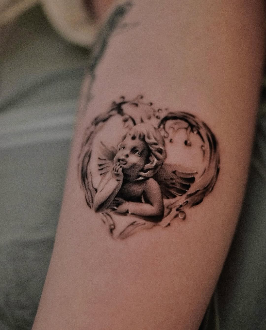 Vintage angel tattoo framed in ornamental heart