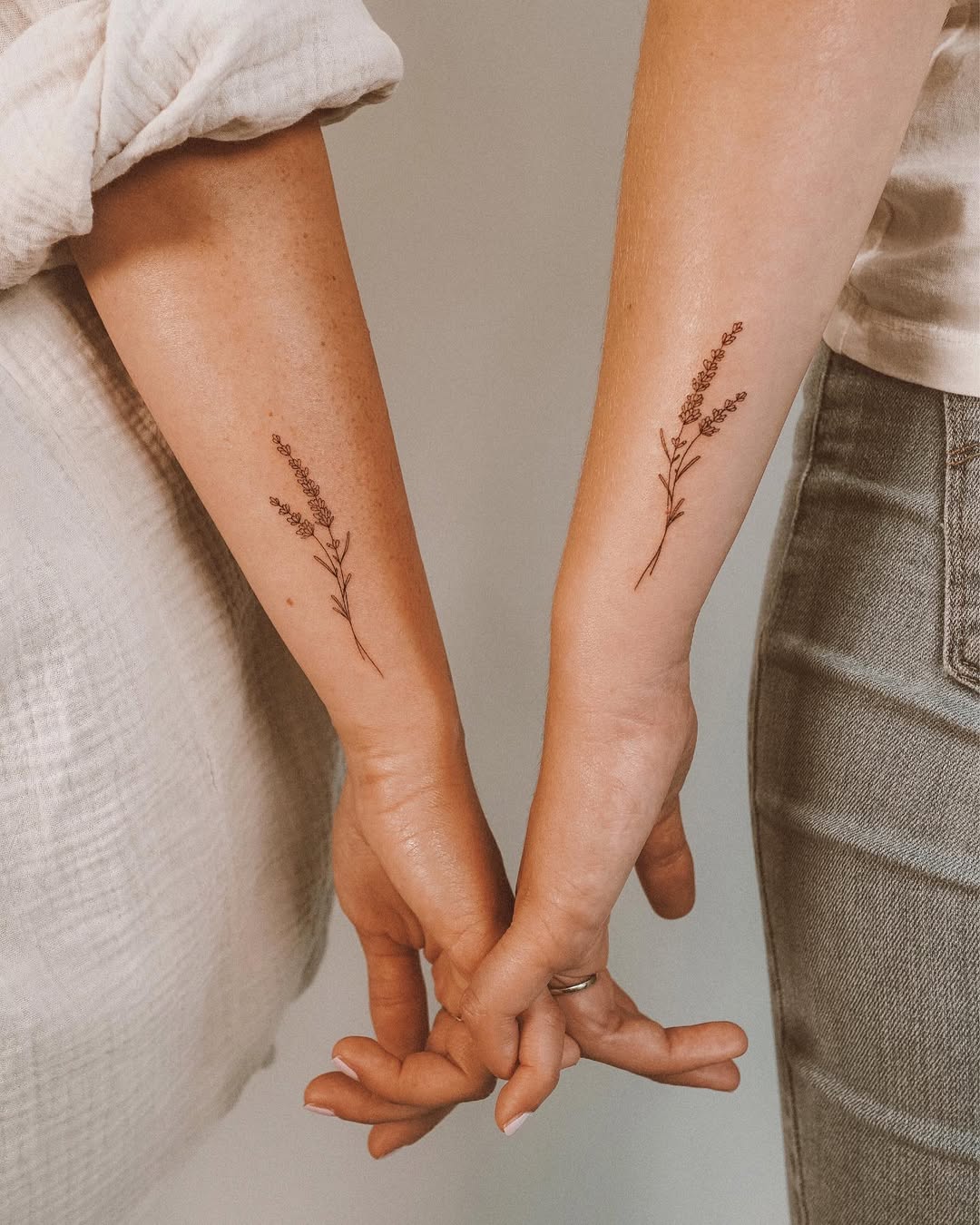 Delicate lavender tattoos symbolize friendship forever