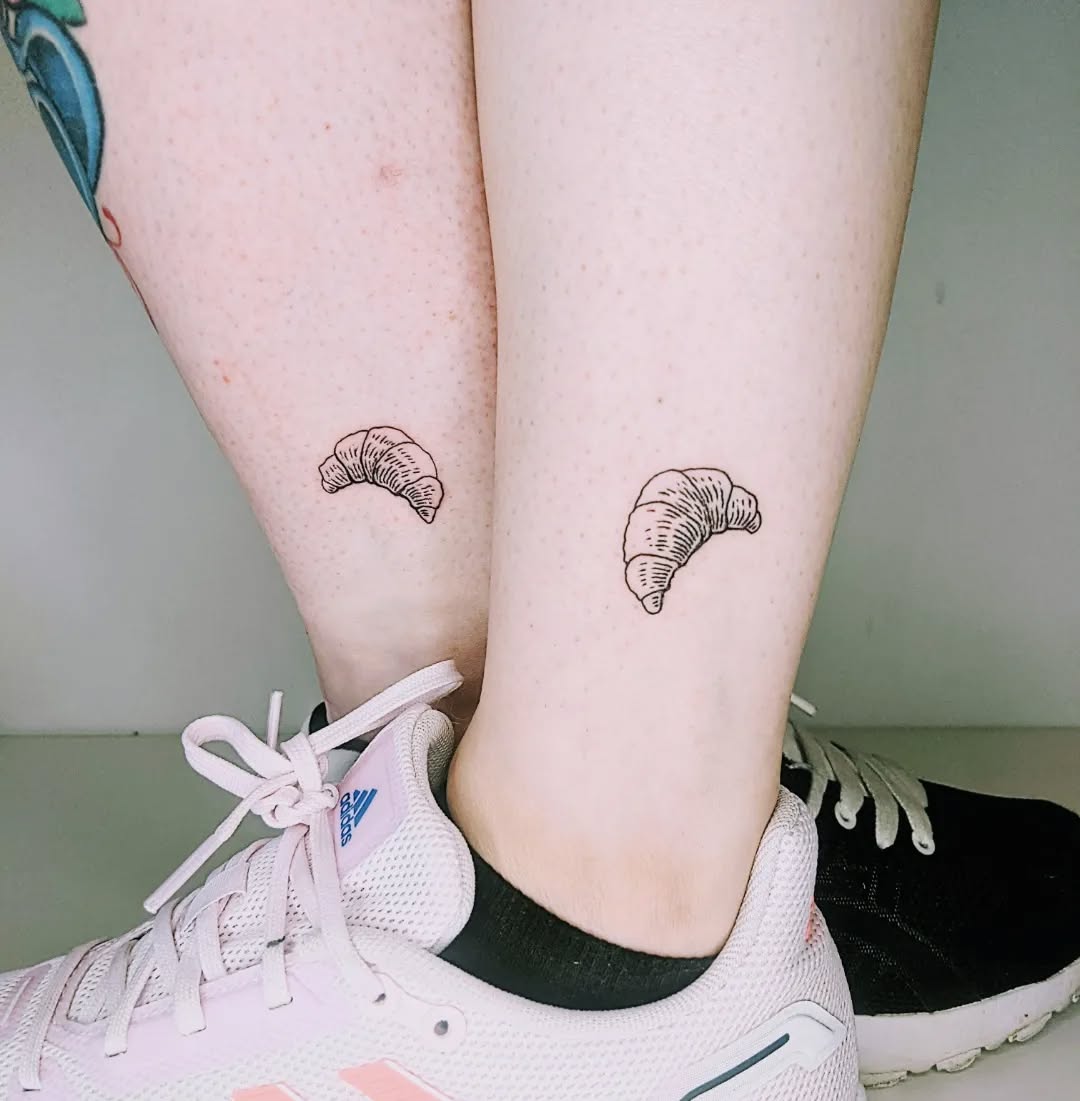 Charming croissant tattoos on ankle.