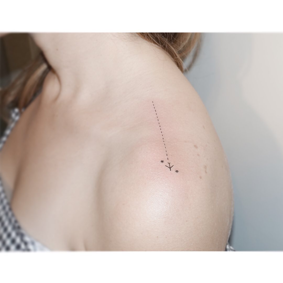 Stylish minimalist airplane tattoo on shoulder