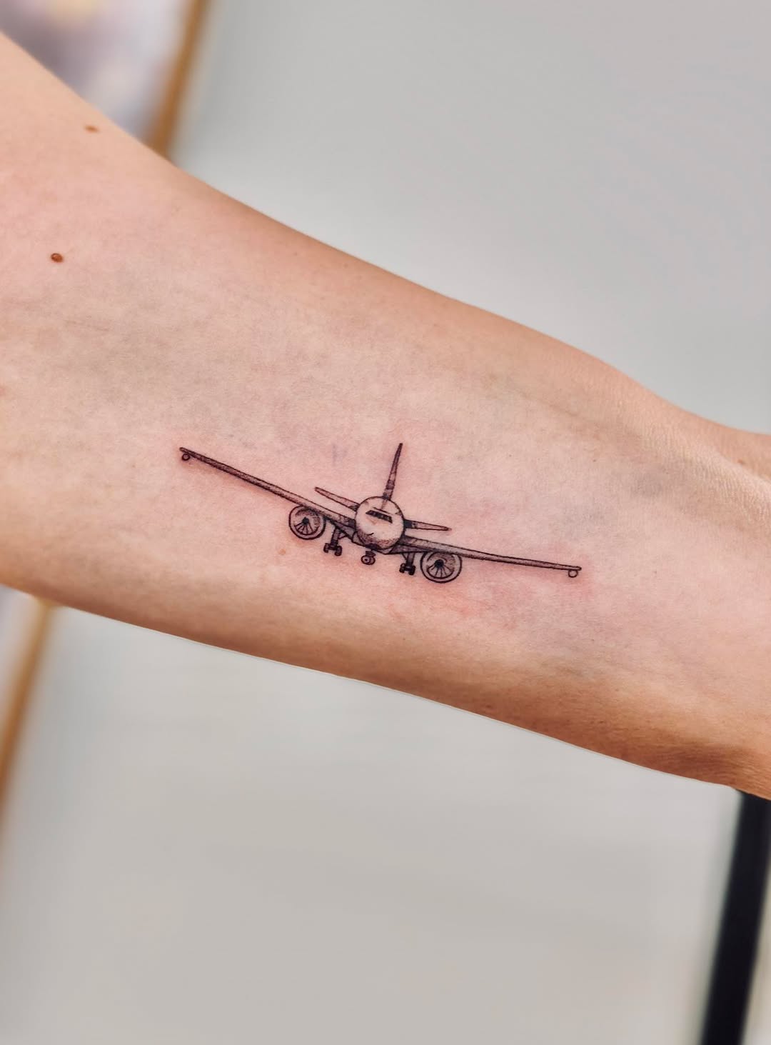 Minimalistic airplane tattoo with intricate details