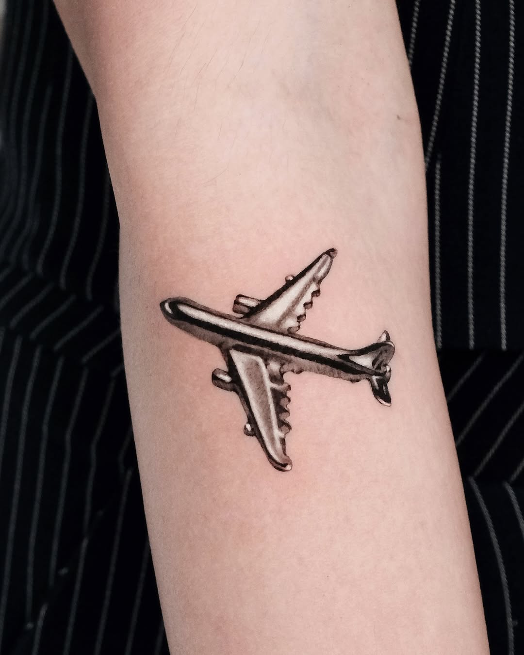 Stylish airplane tattoo on a unique location