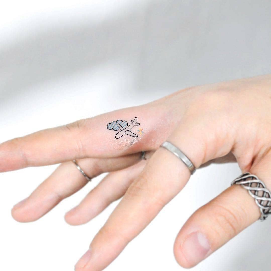 Charming airplane tattoo on the hand