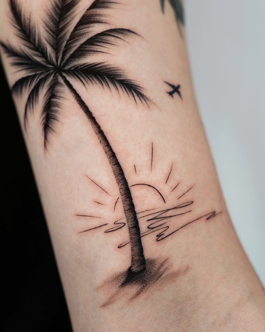 Tranquil vibes of palm tree and sunset tattoos