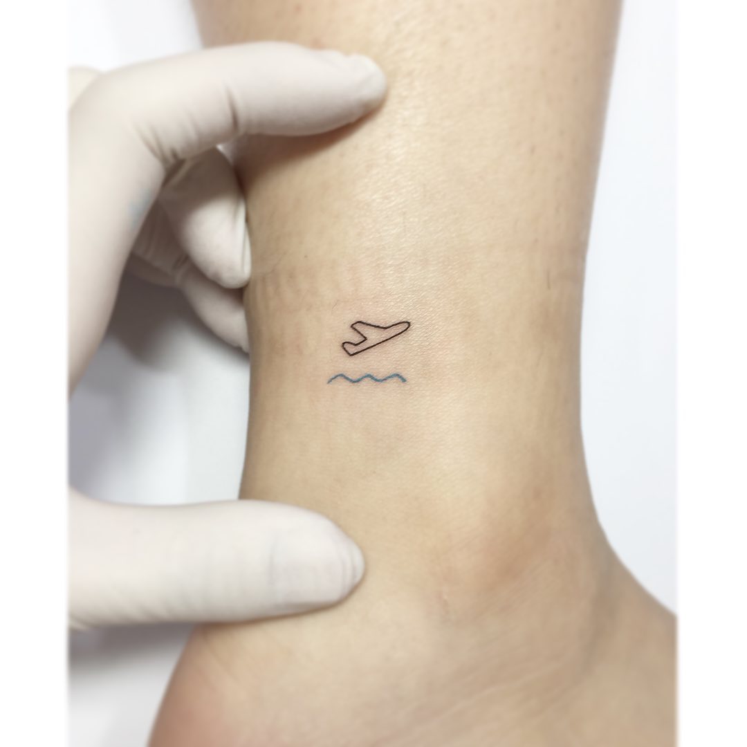 Charming minimalist airplane tattoo design