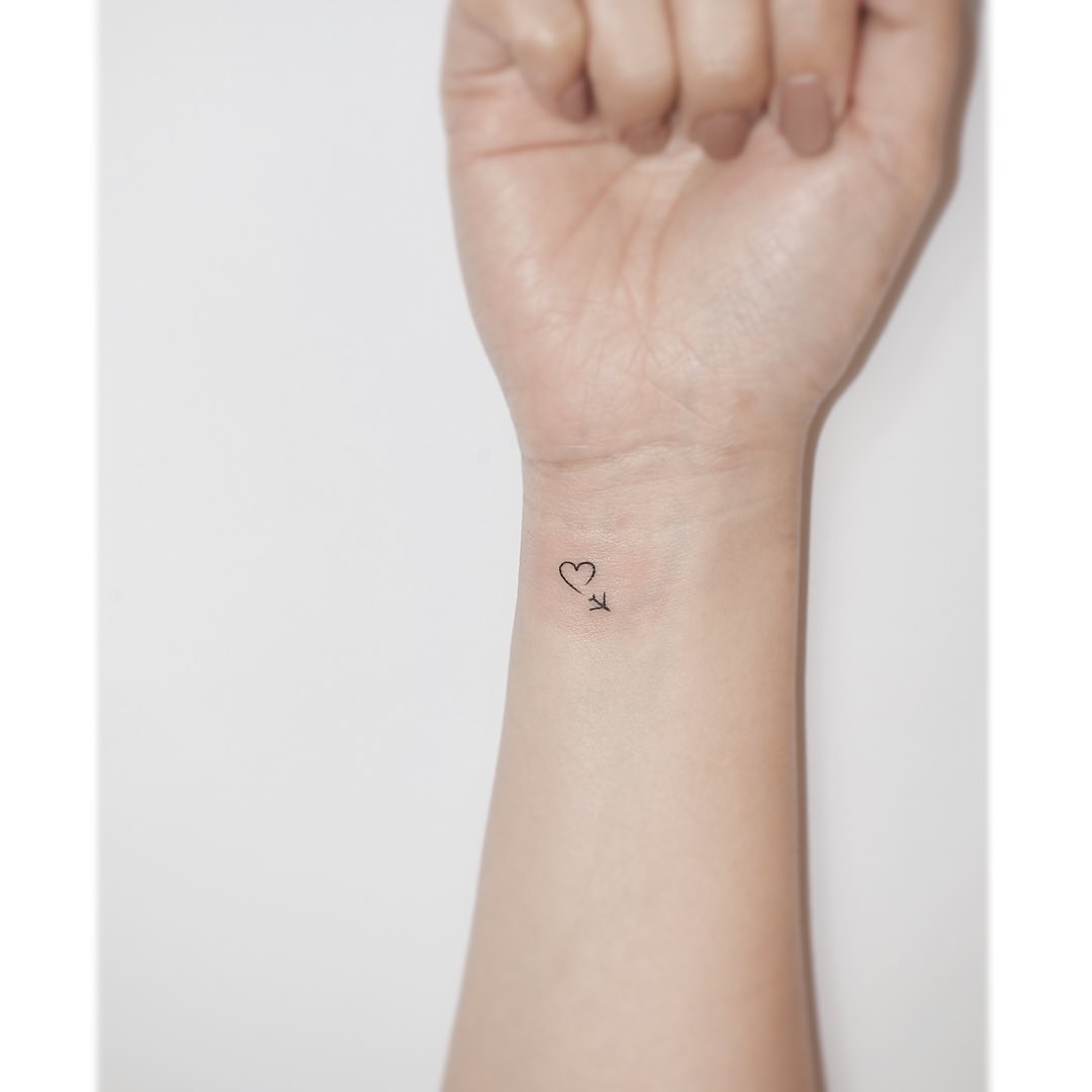 Minimalist Airplane Tattoo with Heart Accent