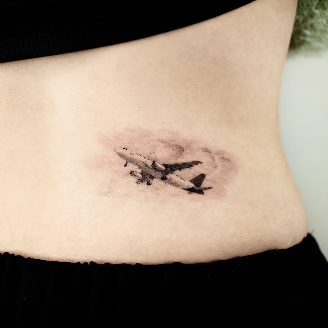Stylish airplane tattoo for travel enthusiasts