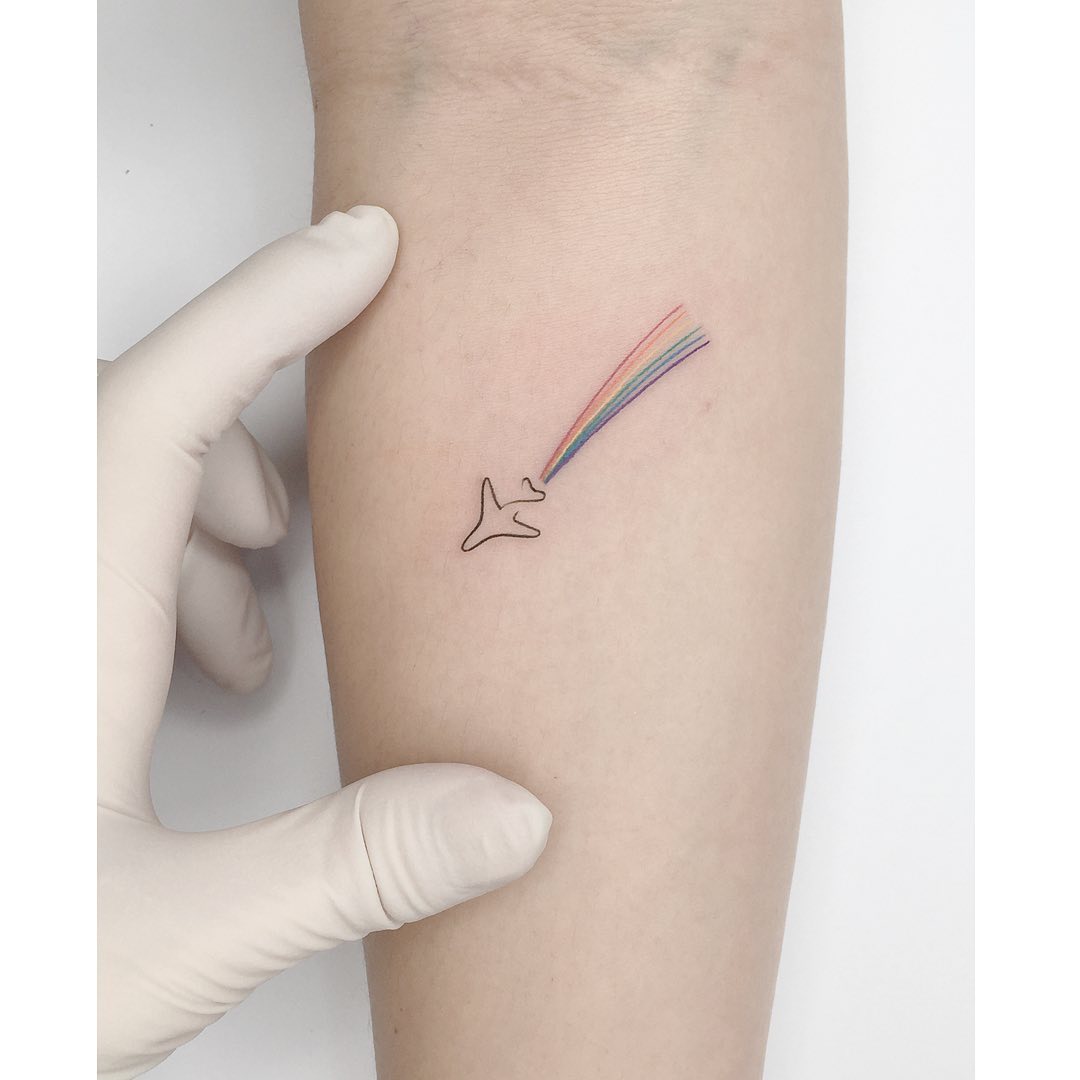 Colorful airplane tattoo with playful vibes