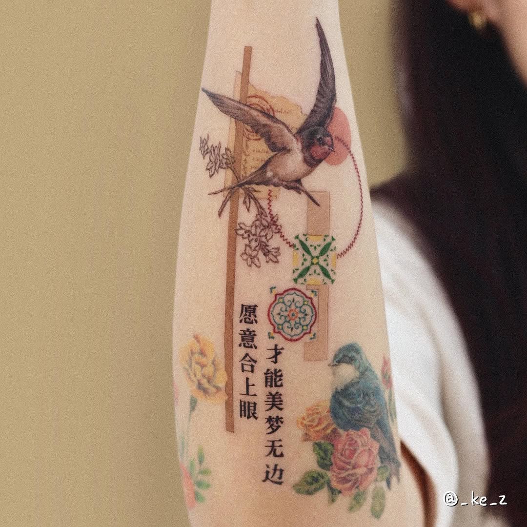 Beautiful swallow tattoo with floral accents