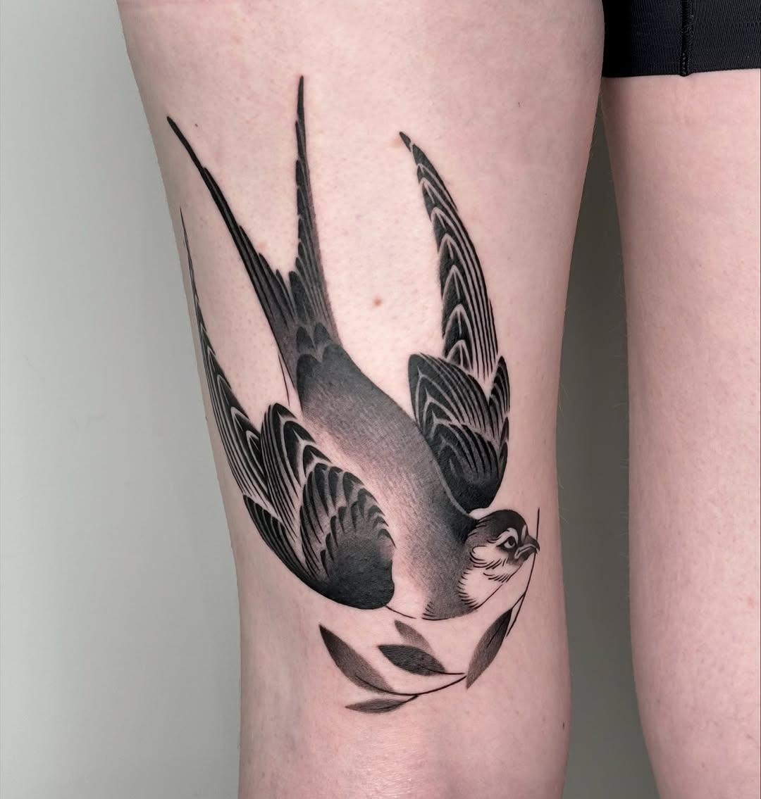 Elegant swallow tattoo with intricate details