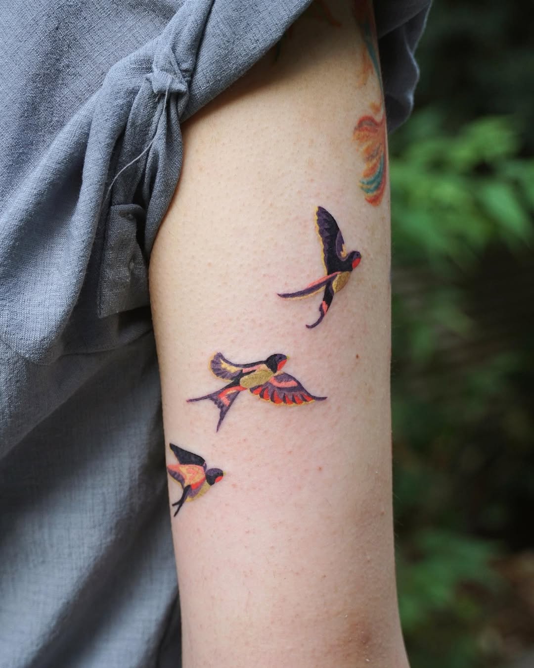 Colorful Swallows in Flight Tattoo Design