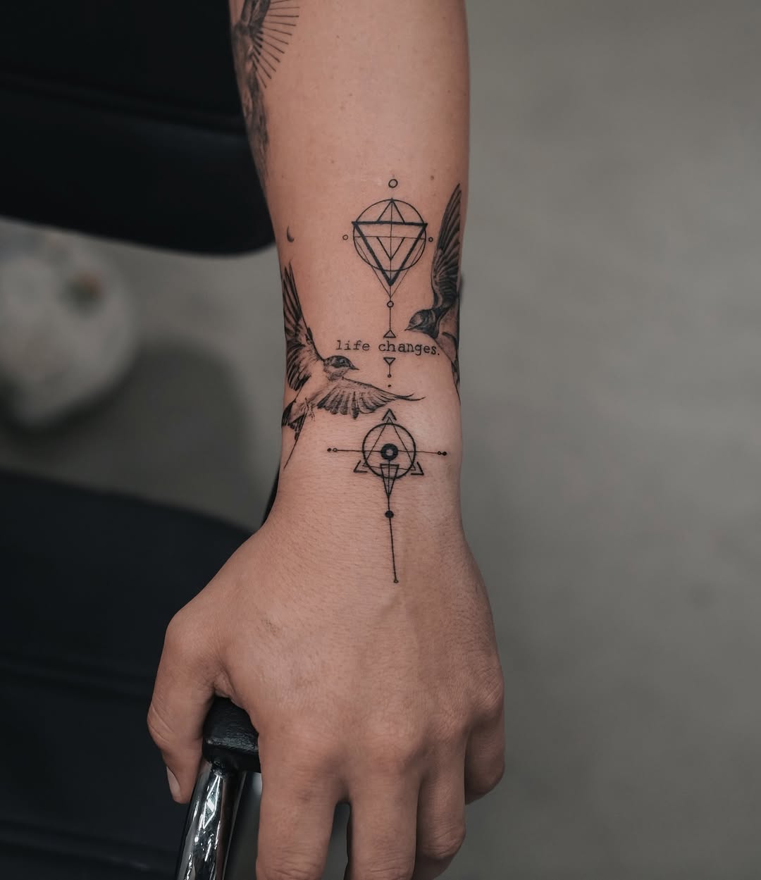 Elegant Swallow Tattoo with Symbolic Elements