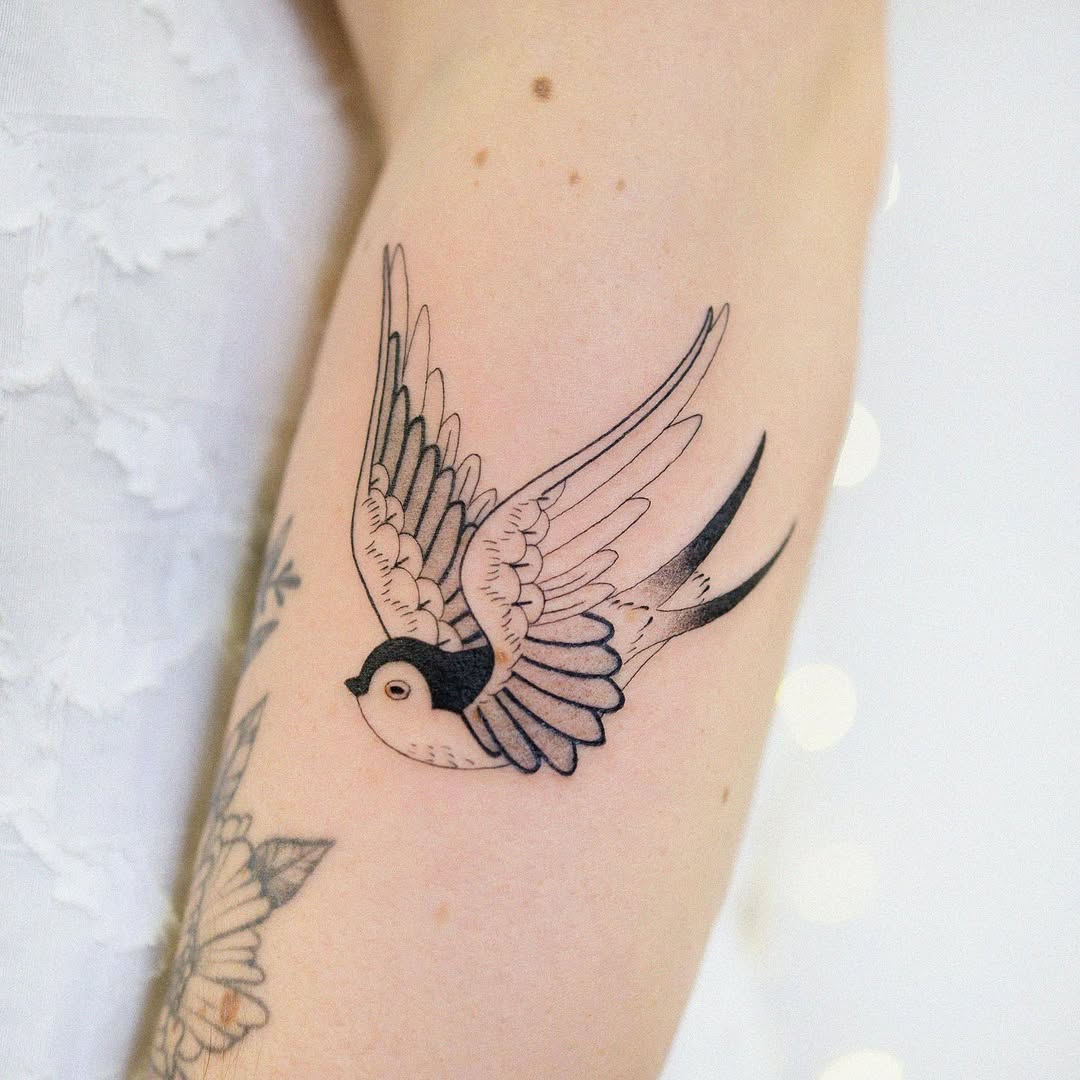 Elegant swallow tattoo in flight