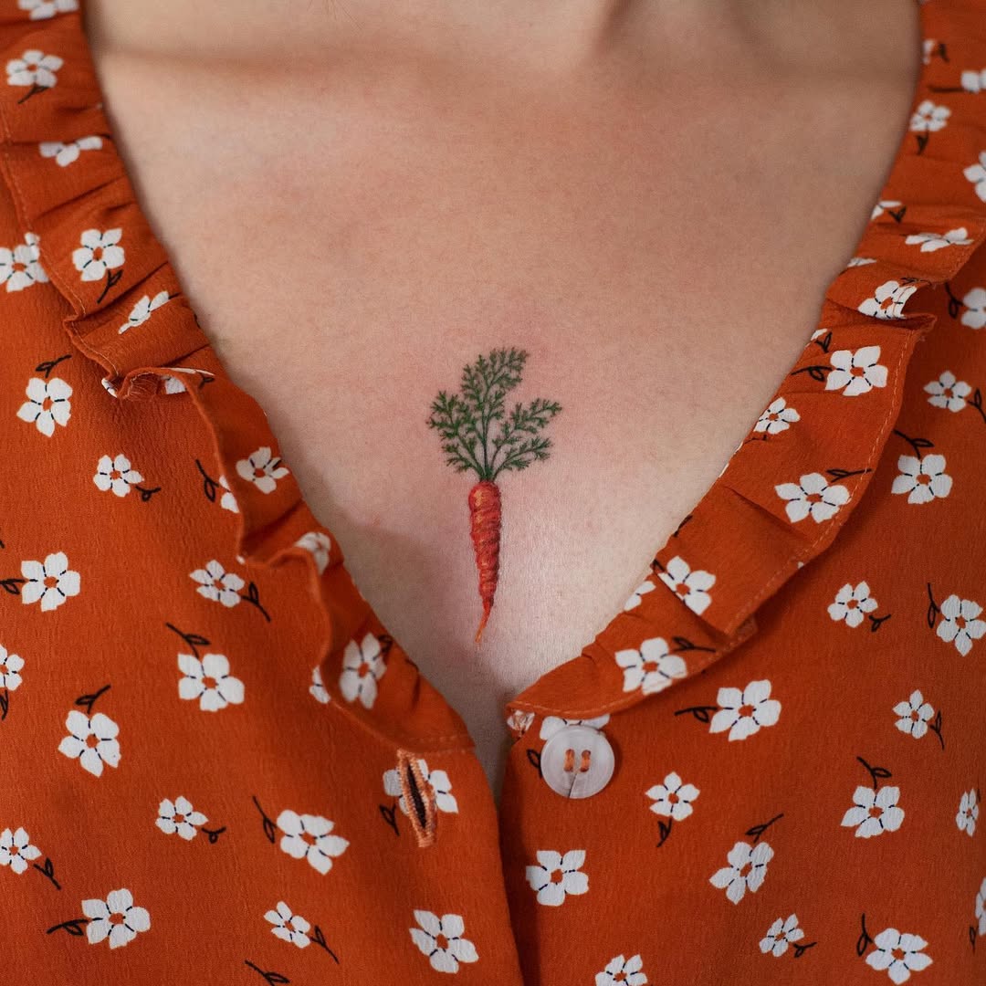 Charming carrot tattoo on the chest area