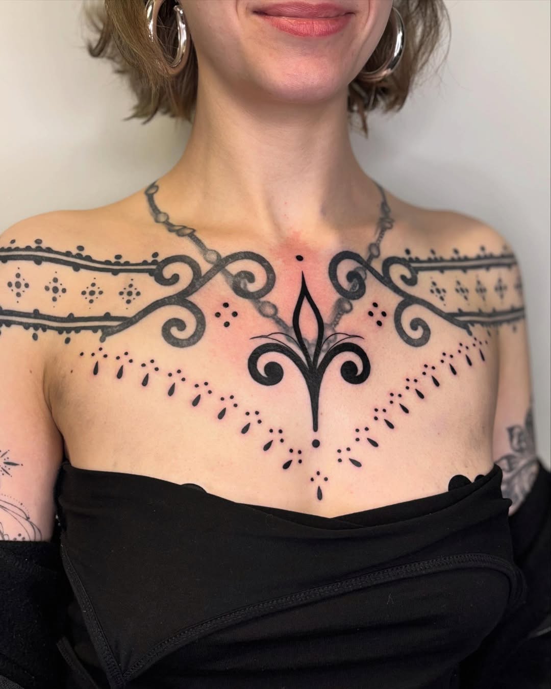 Intricate Chest Tattoo with Elegant Patterns