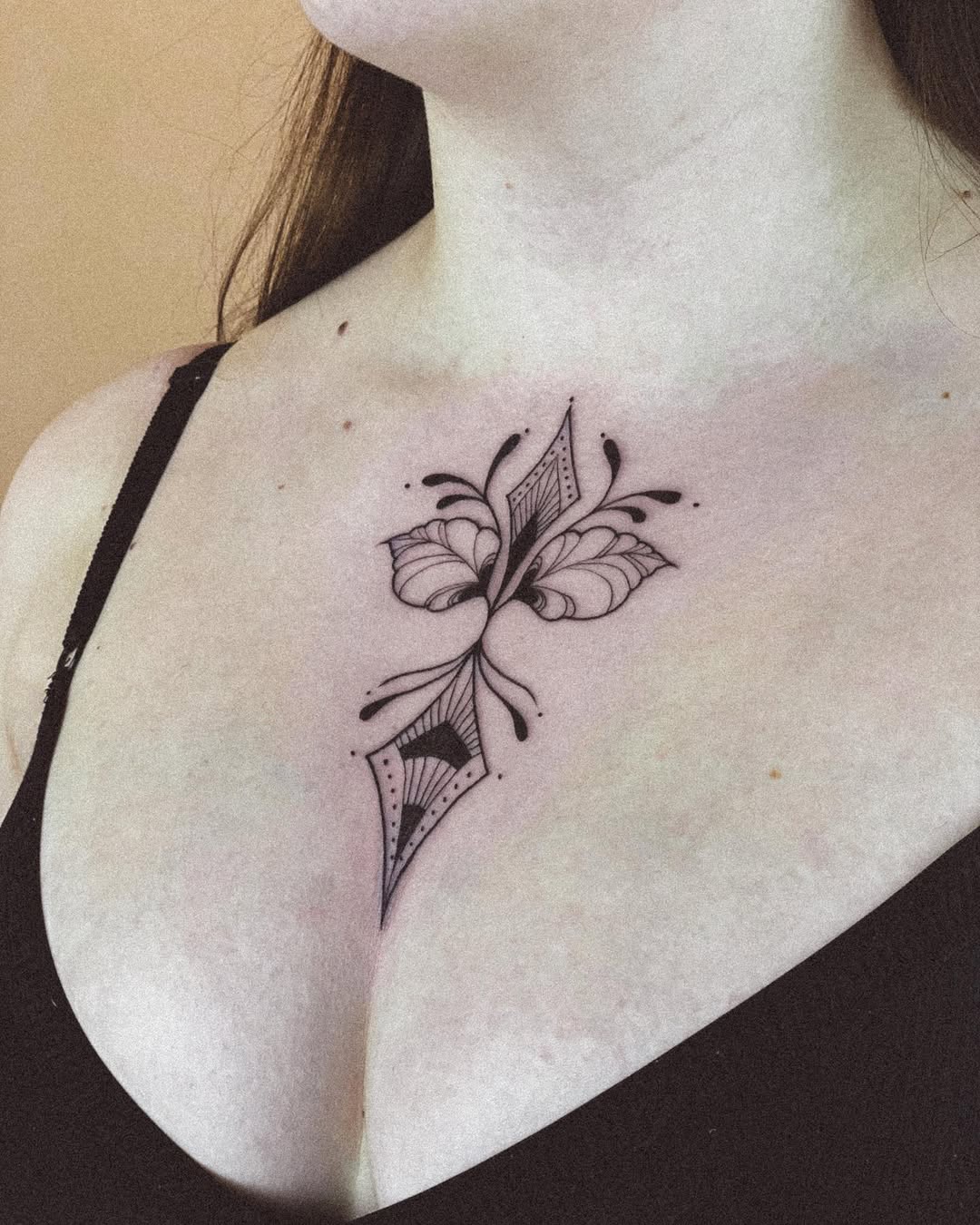 Elegant butterfly tattoo gracing the chest.