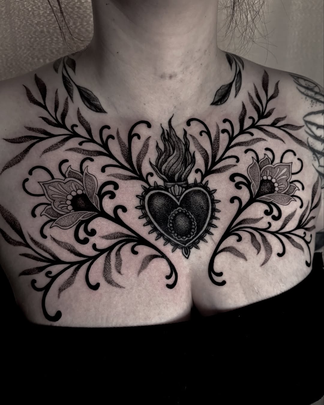 Elegant heart and floral chest tattoo design