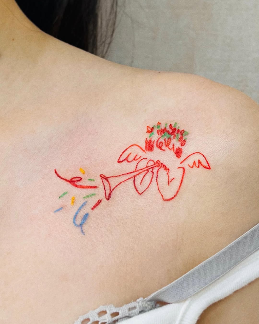 Whimsical angel tattoo on the chest