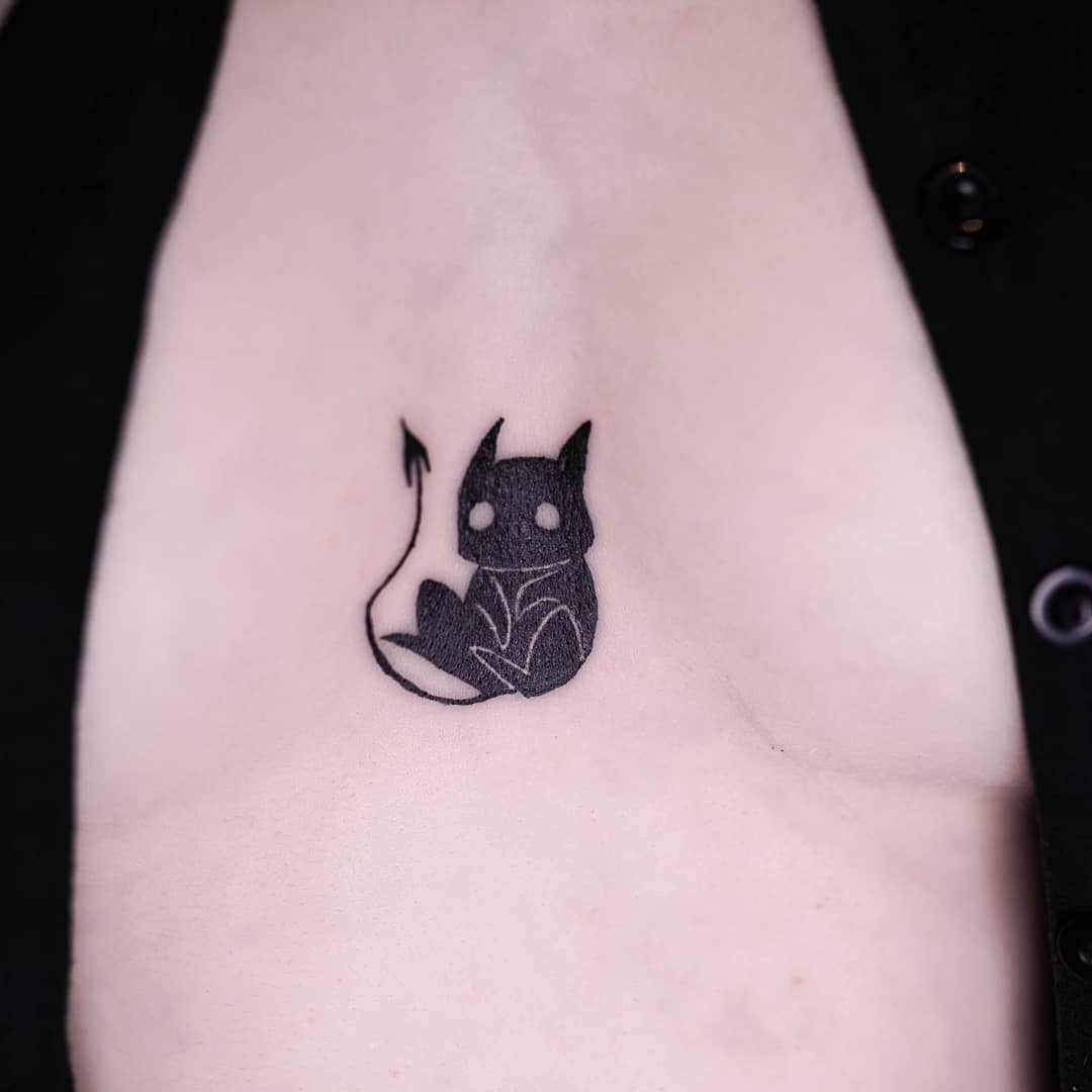 Charming chest tattoo of a playful cat