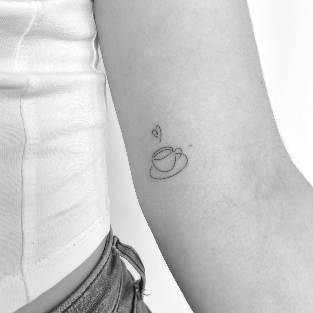 Minimalist coffee cup tattoo with heart