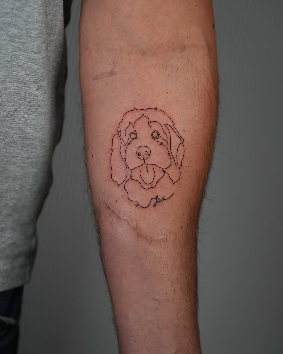 Minimalist dog tattoo with unique line art