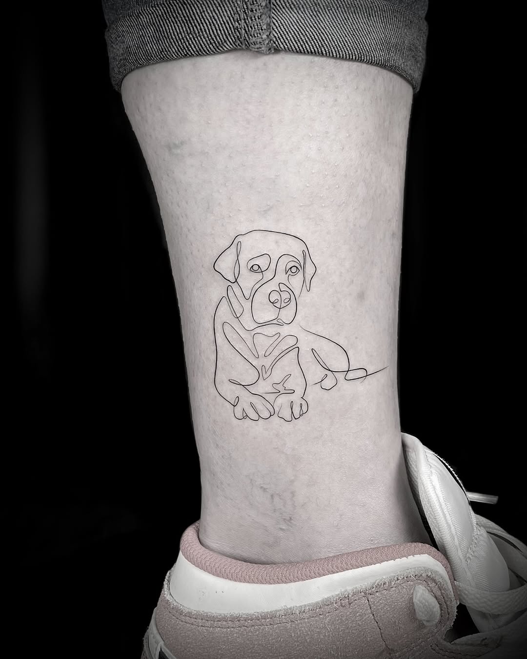 Minimalist dog tattoo in continuous line art