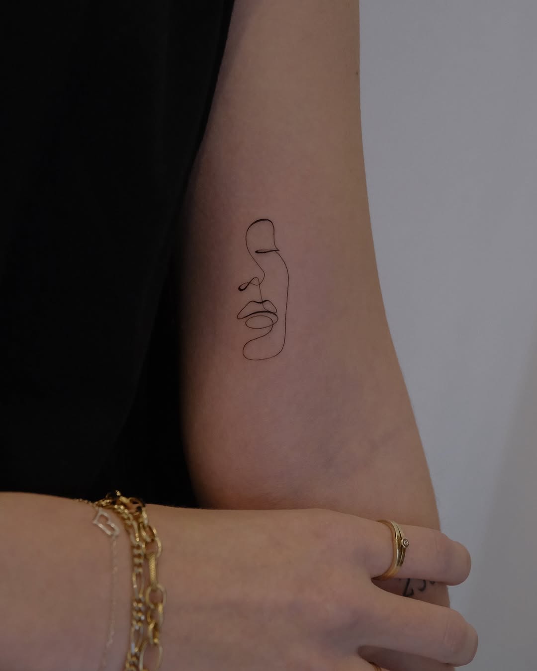 Elegant single line face tattoo design