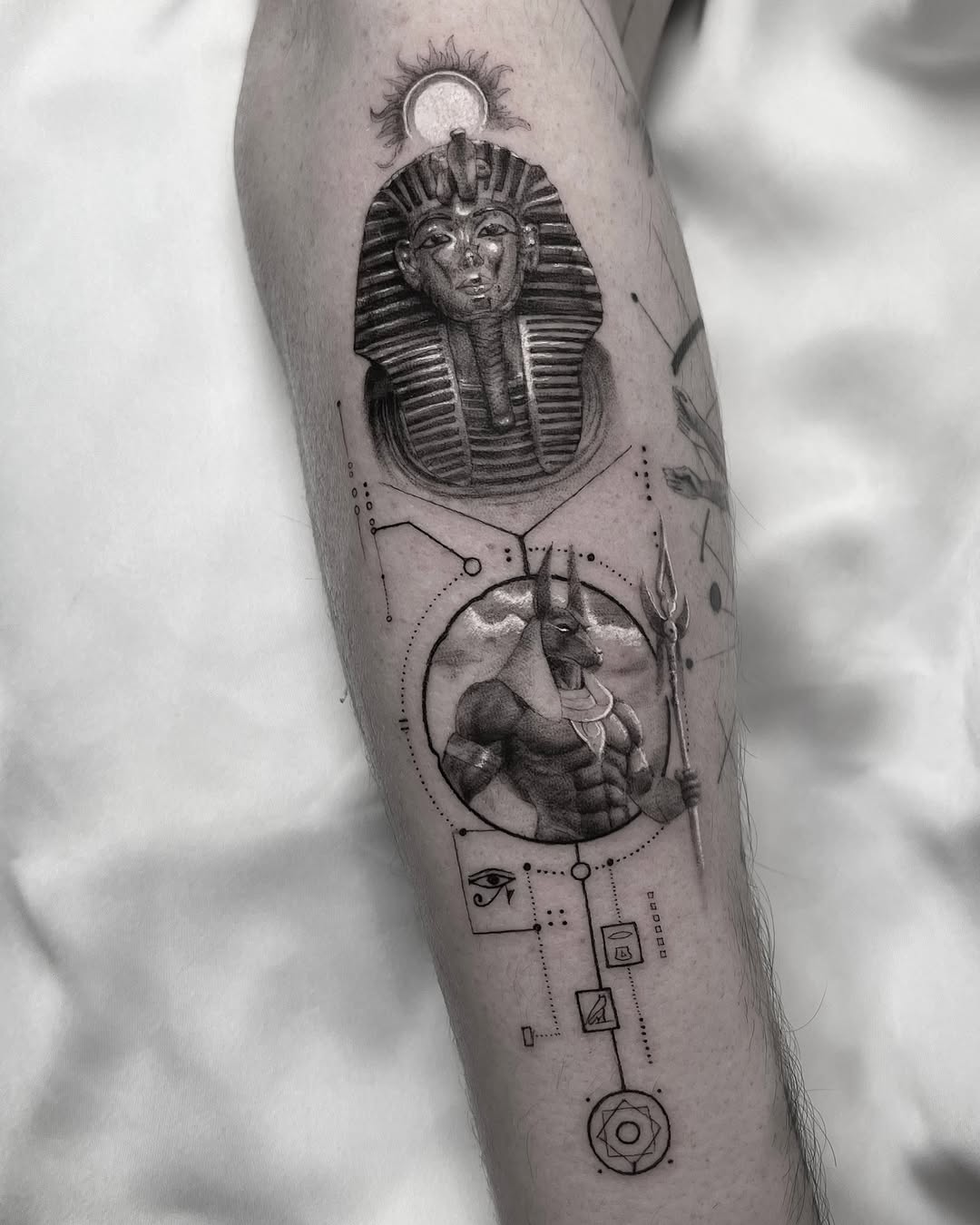 Intricate Egyptian-themed tattoo design on arm