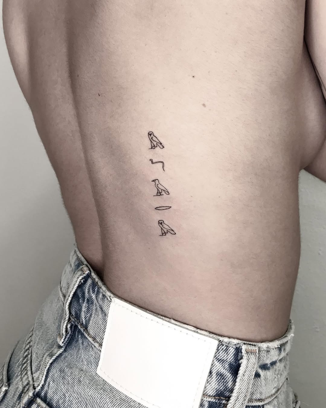 Unique minimalist Egyptian script tattoo design
