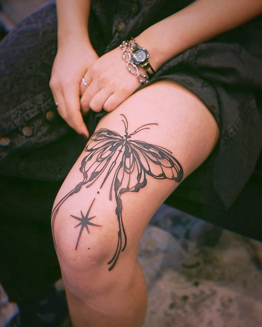Elegant butterfly knee tattoo with star accent