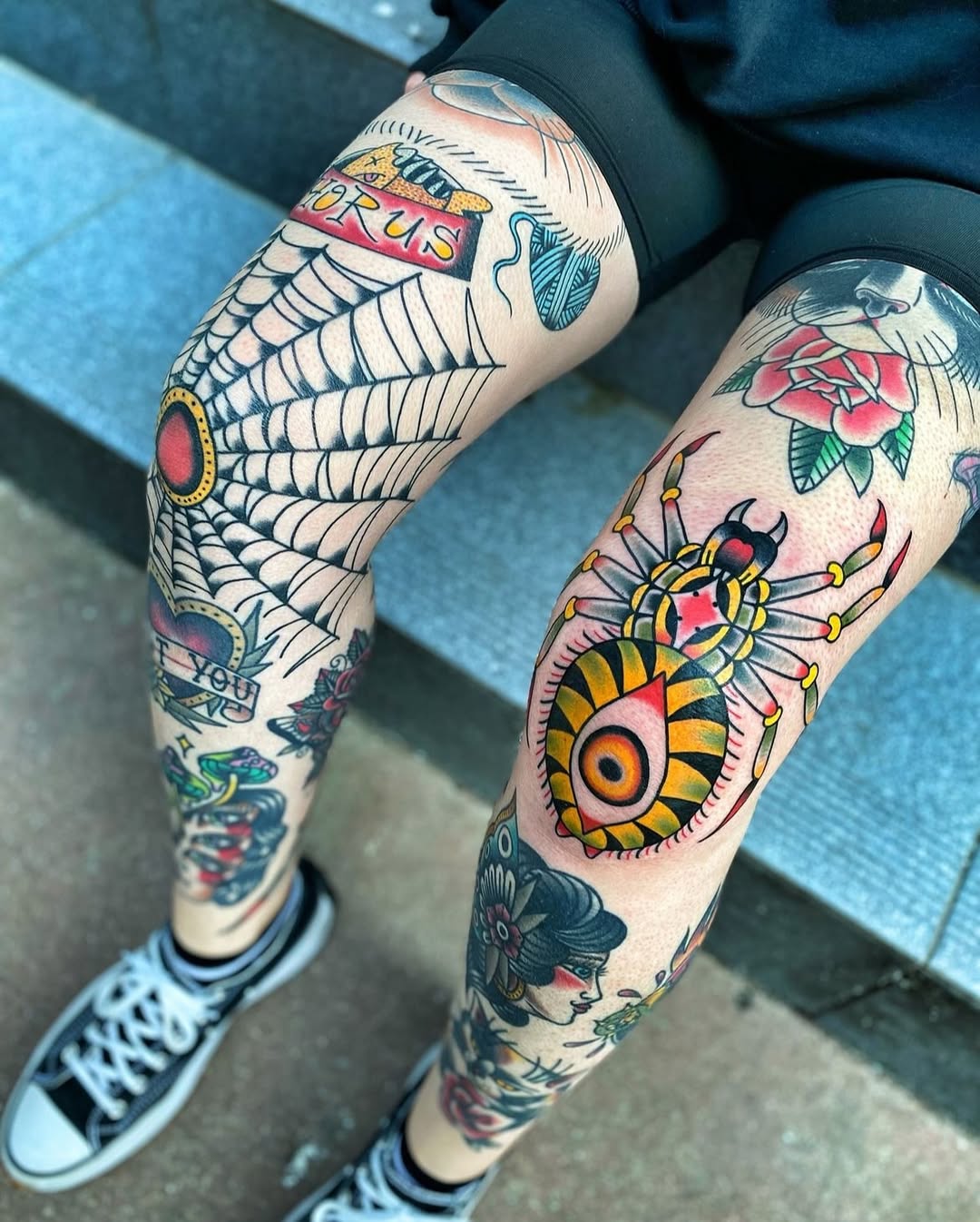 Bold knee tattoos with vibrant spider artwork