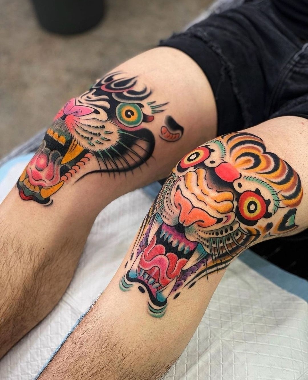 Bold knee tattoos with fierce tiger designs