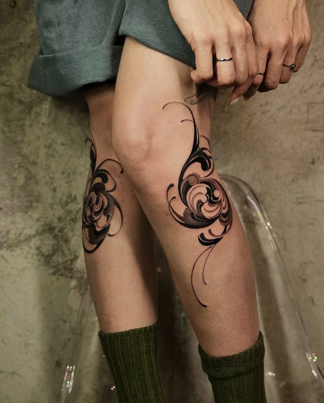 Elegant floral knee tattoo design with swirls