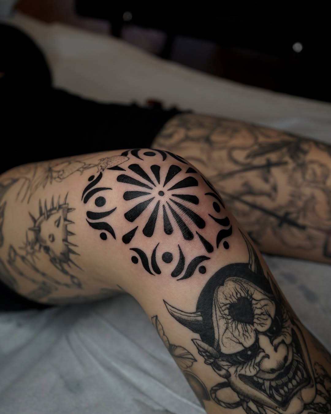 Stunning floral knee tattoo in bold black ink