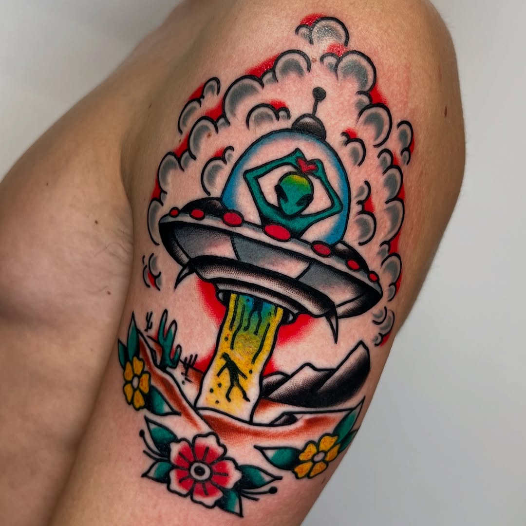 Vibrant UFO tattoo with floral accents and details