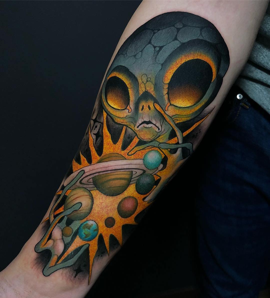 Vibrant alien tattoo with cosmic elements