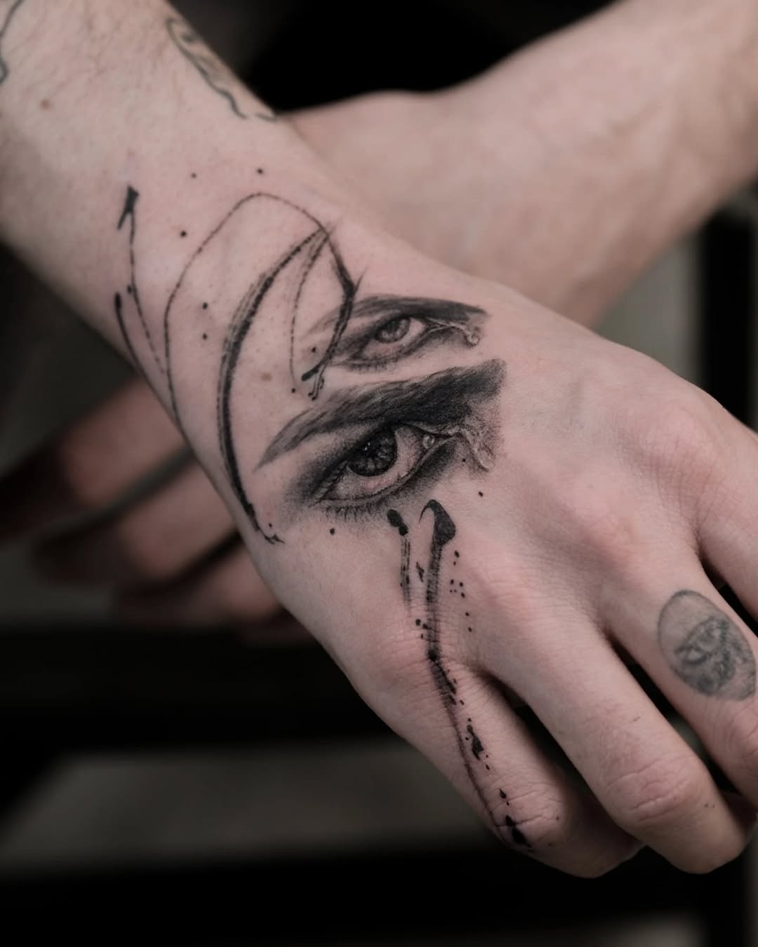 Intricate hand tattoo featuring expressive eyes